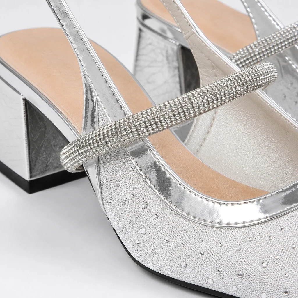 Close-up detail of crystal strap and shimmering upper on the pumps
