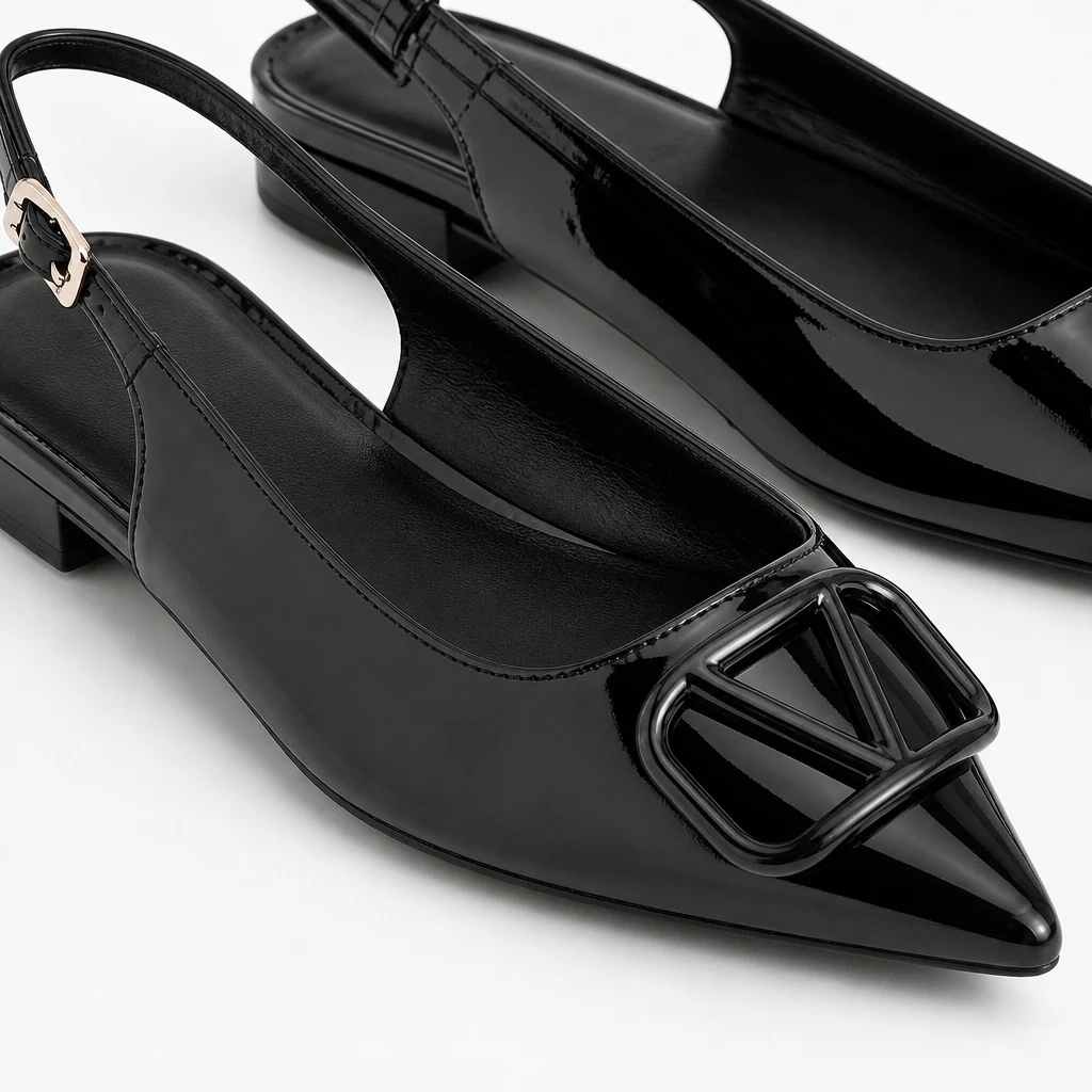 Close-up of glossy black patent-look upper and buckle detail on the dress flat